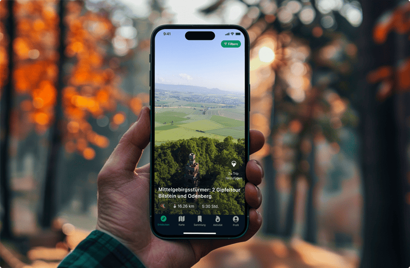 Hand holding phone with Triphunt App